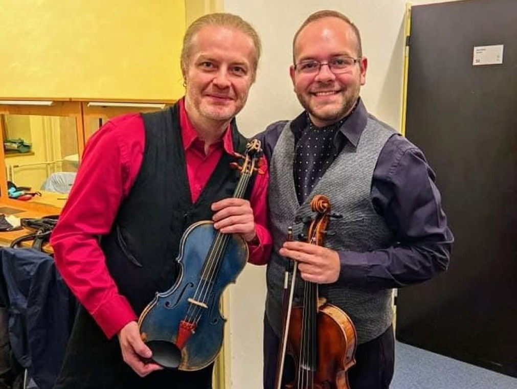 Photo of Pavel Šporcl & Vojtech Bélu Botoš holding instruments posing for the camera.