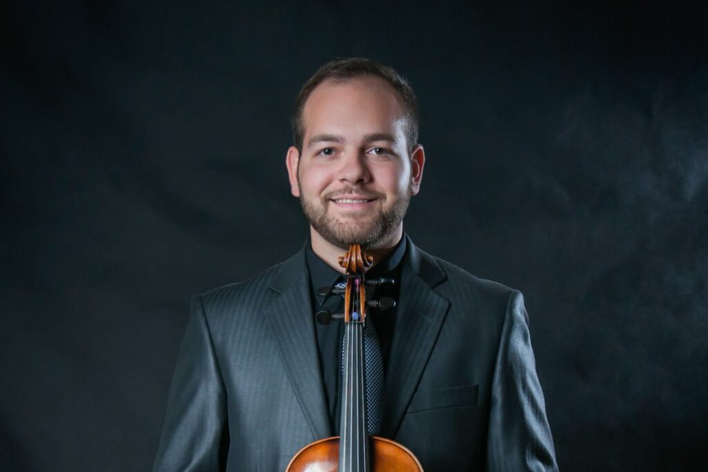 Portrait of Vojtech Bélu Botoš holding a viola. 